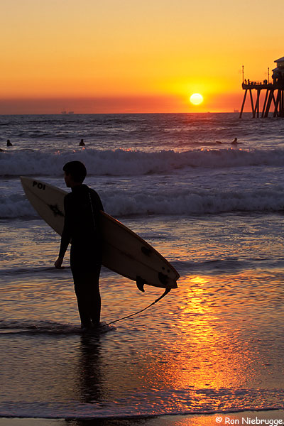 A surfer at Sunset, Huntington Beach, California.